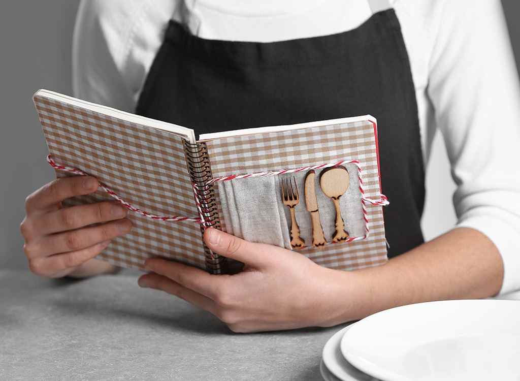 Woman holding cookbook