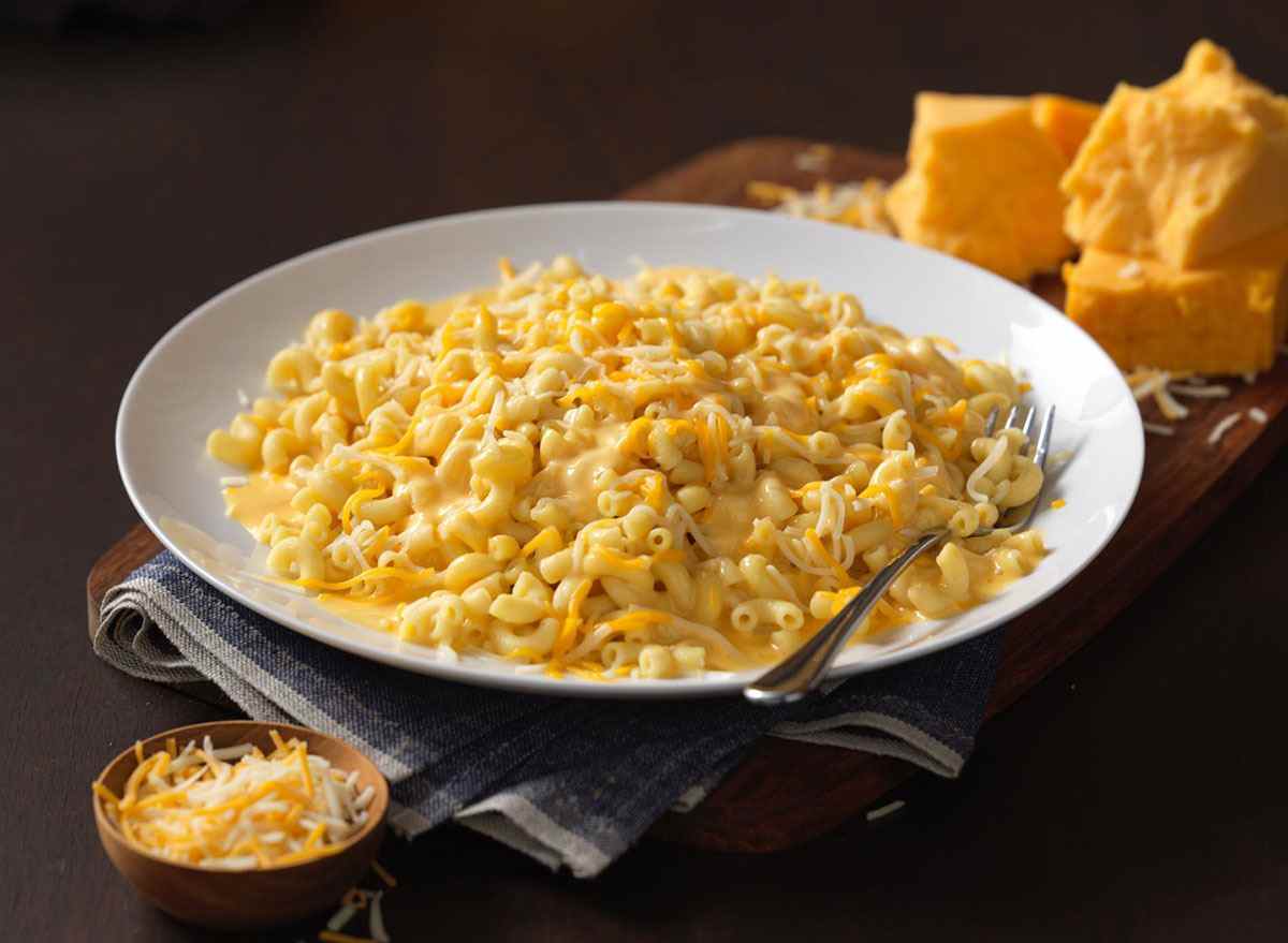 noodles world kitchen wisconsin mac and cheese bowl with spoon and cheese wedge