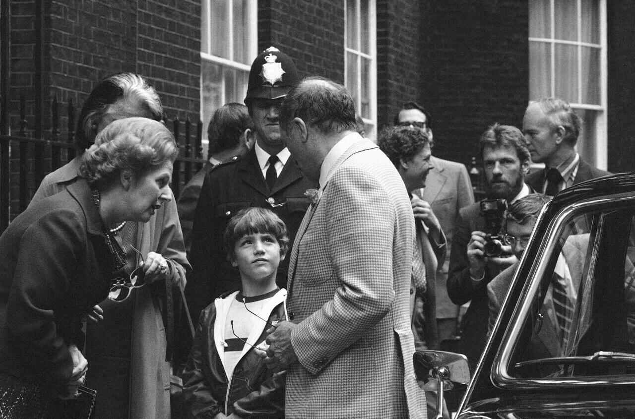 In this June 25, 1980, file photo, British Prime Minister Margaret Thatcher, left, Canadian Prime Minister Pierre Trudeau, centre, facing left, and his son, future Canadian PM Justin, then 8, speak outside No. 10 Downing Street, in London.