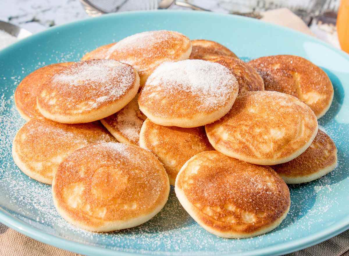 mini pancakes on plate with powdered sugar
