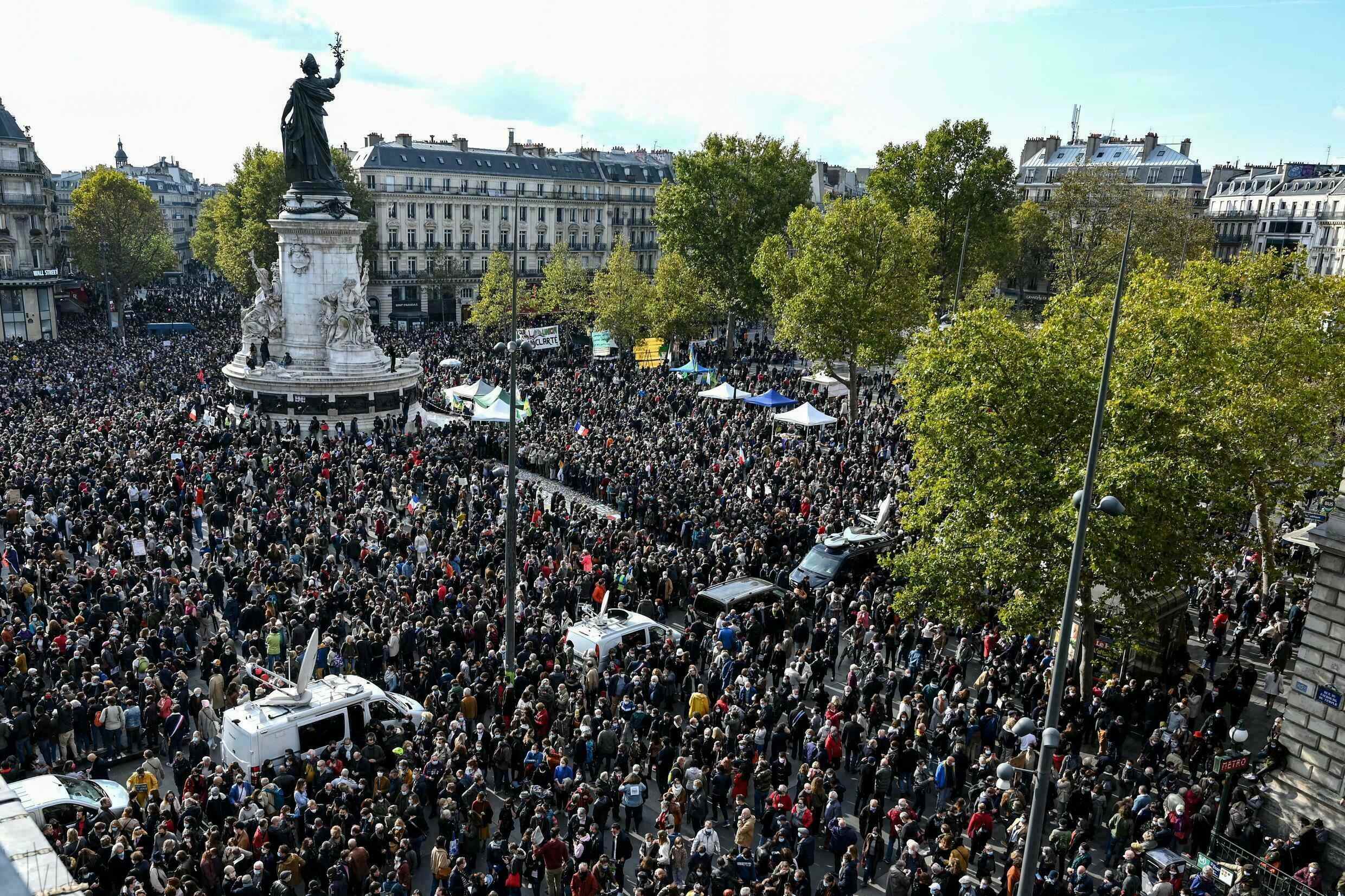 People gather on Place de la République in eastern Paris on October 18, 2020, in homage to teacher Samuel Paty two days after he was beheaded.