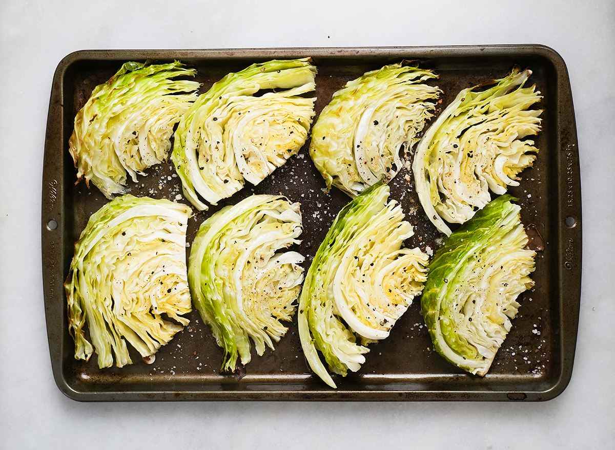 cooked cabbage wedges on a baking sheet