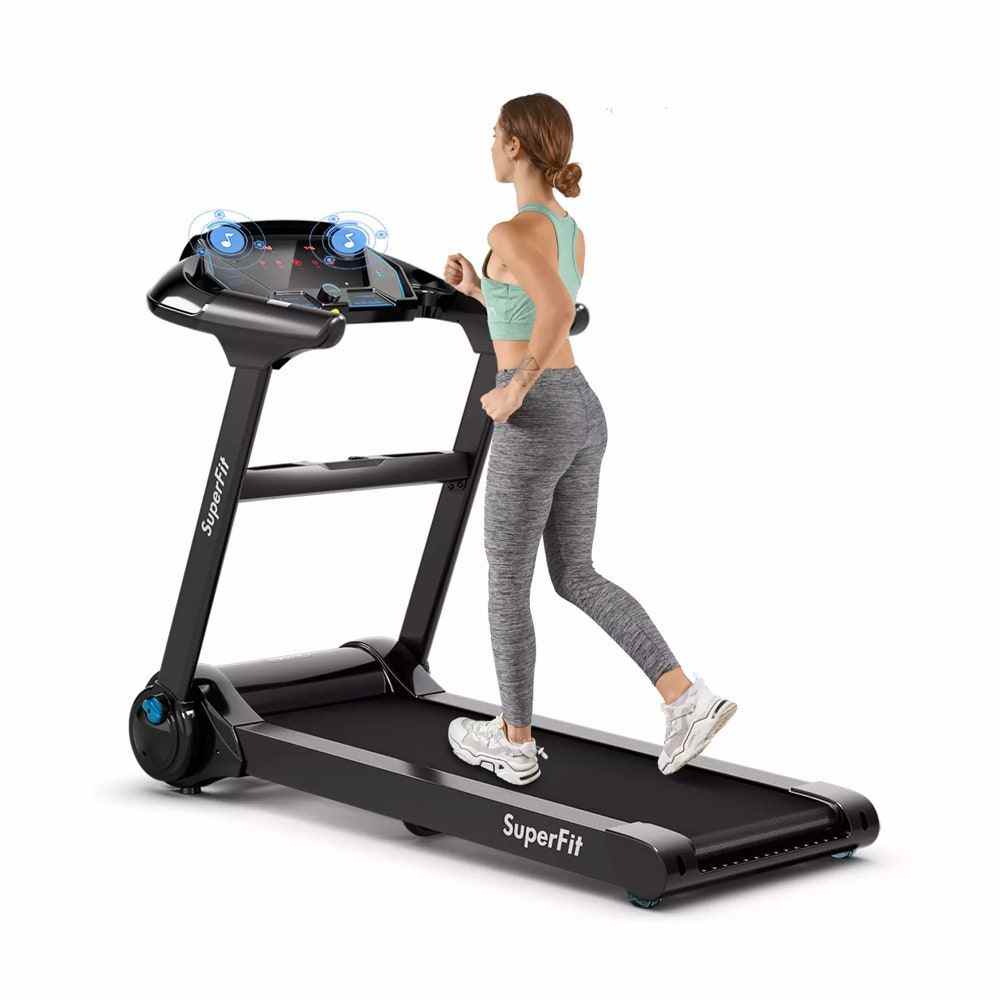 Woman with hair tied and wearing activewear walking on Costway 2.25HP Folding Treadmill in black