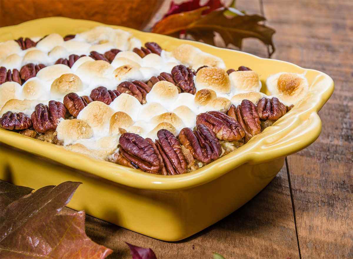 tray of sweet potato casserole topped with pecans and marshmallows