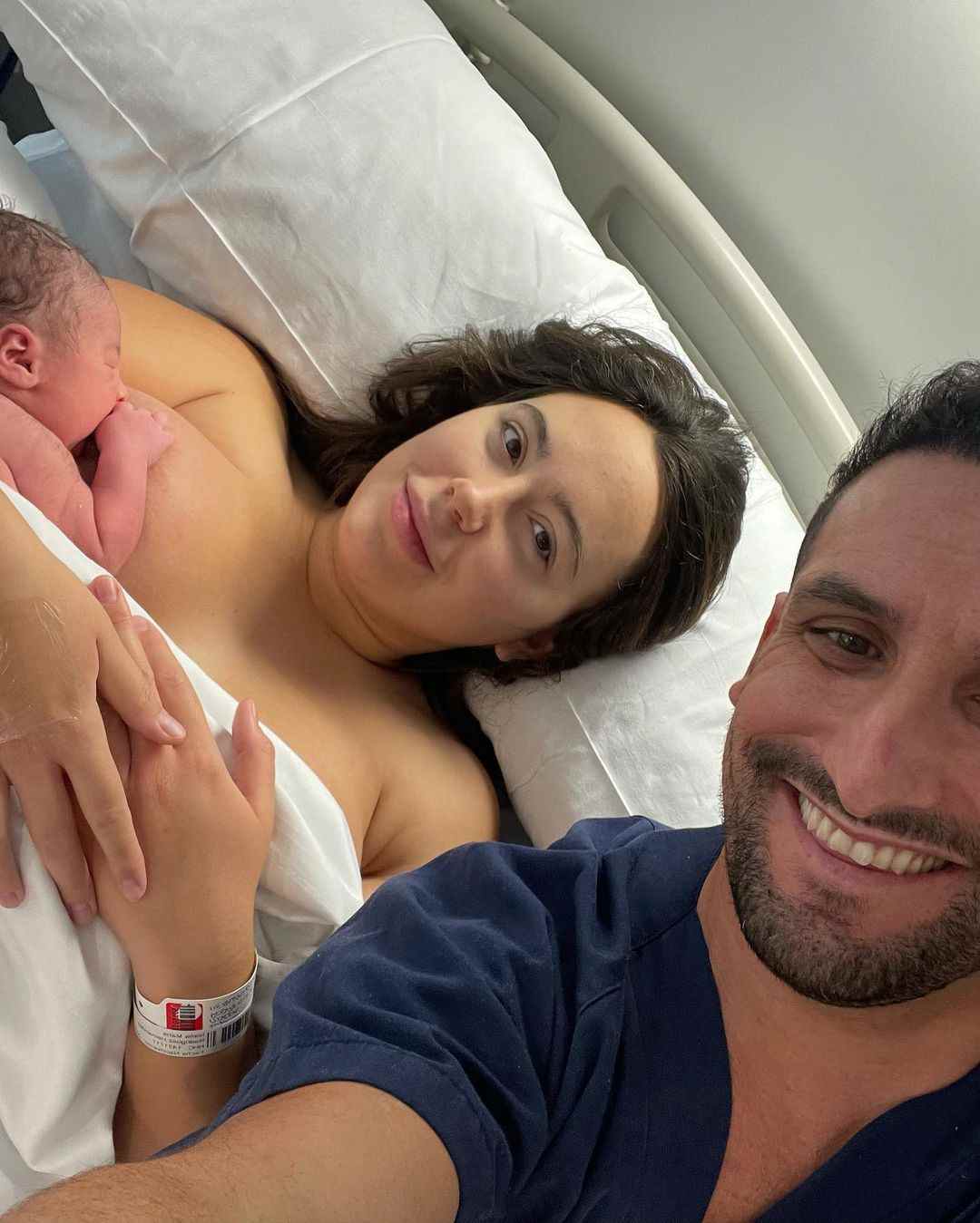 Ivana Rodriguez poses with Carlos and their newborn