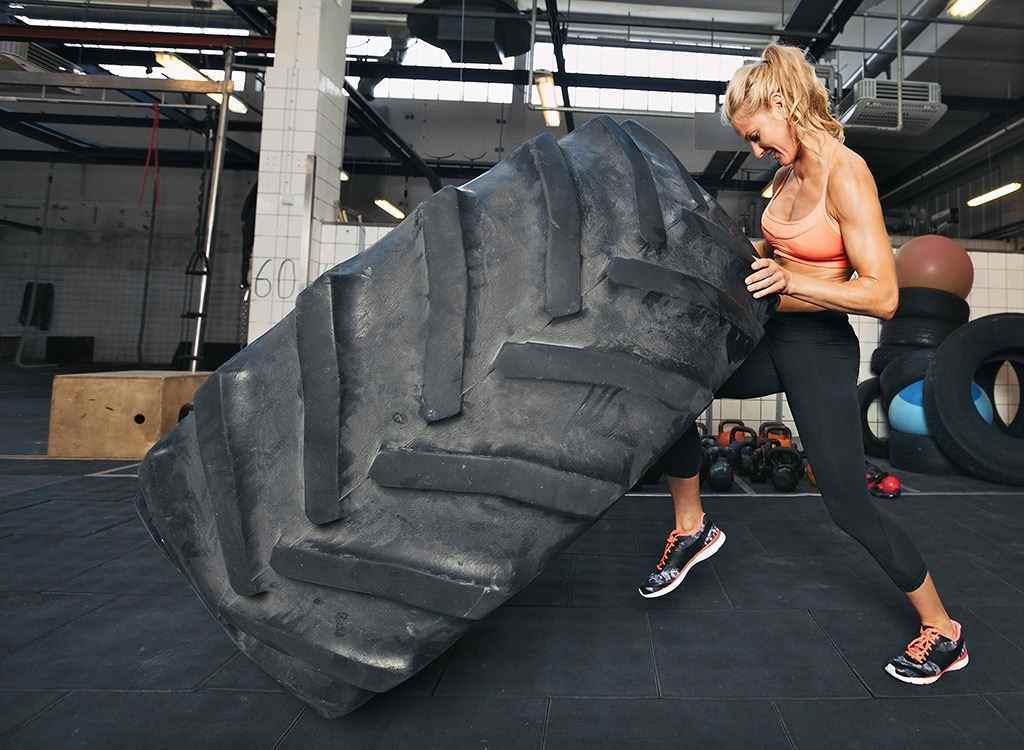 woman lifting tire