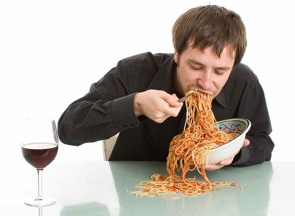Best worst foods sleep - person eating too much pasta
