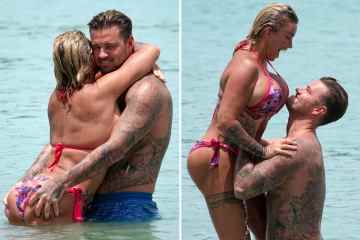 Katie Price shows off her new boobs as fiance Carl  grabs her bum in the sea