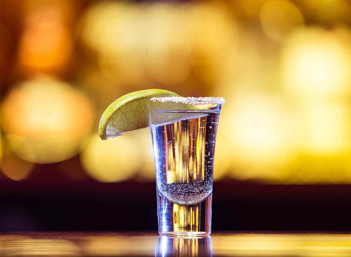 shot of tequila with salt rim and lime wedge