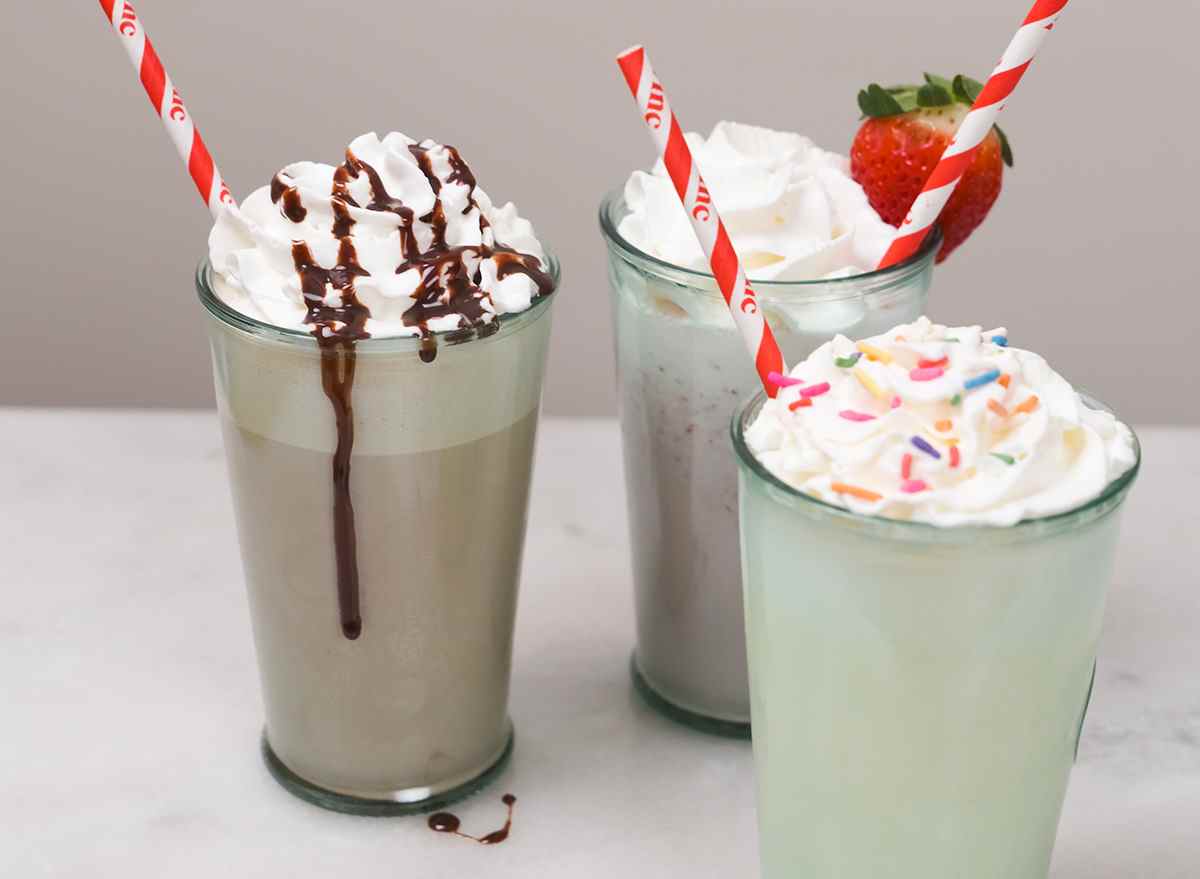 three types of milkshakes with red straws