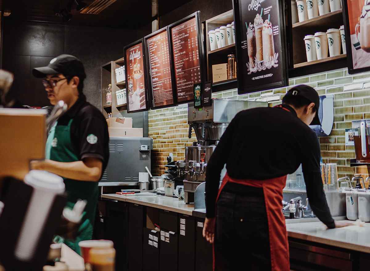 Starbucks employees serving customers behind the counter