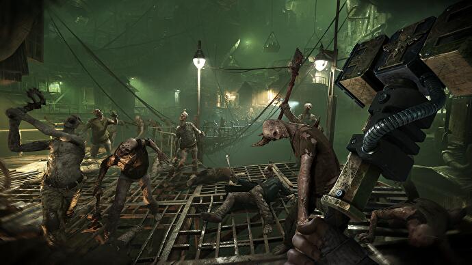 Darktide-Vorschau – viele Zombies, die den Spieler in einem grün gefärbten Raum angreifen
