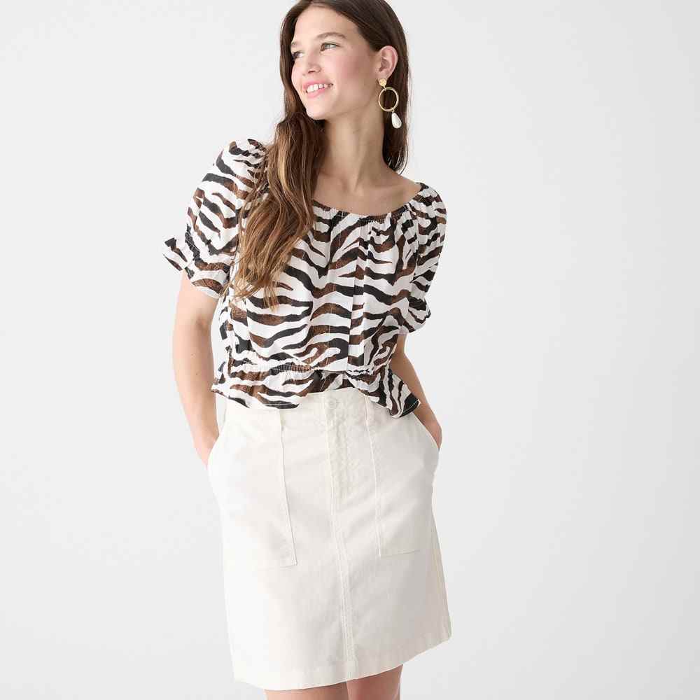 White J.Crew Garment-Dyed Utility Mini Skirt on model wearing brown zebra print shirt