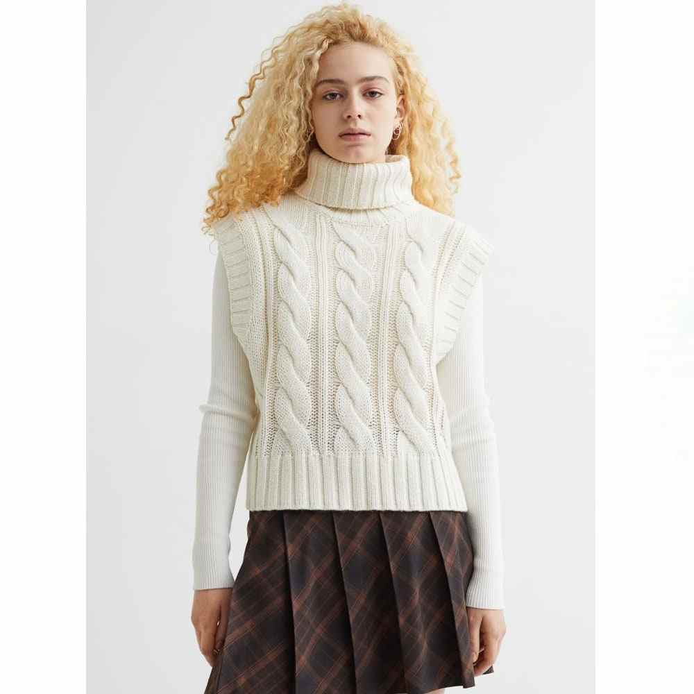 White H&M Turtleneck Sweater Vest on model wearing brown plaid skirt