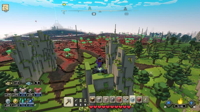 Minecraft Legends Review – Screenshot von Minecraft Legends, ein hoher Kamerawinkel einiger Steinstrukturen in grünen Hügeln