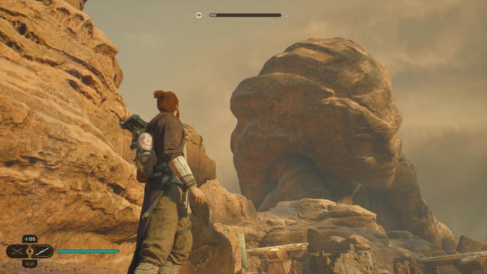 Star Wars Jedi Survivor-Rezension – Screenshot, der zeigt, wie Cal und BD-1 eine riesige Statue auf Jedha hinaufschauen