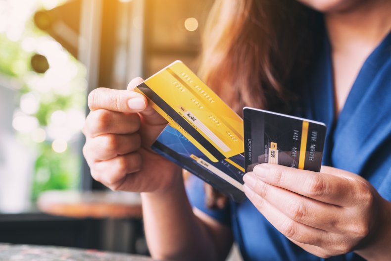 Person holding several credit cards.