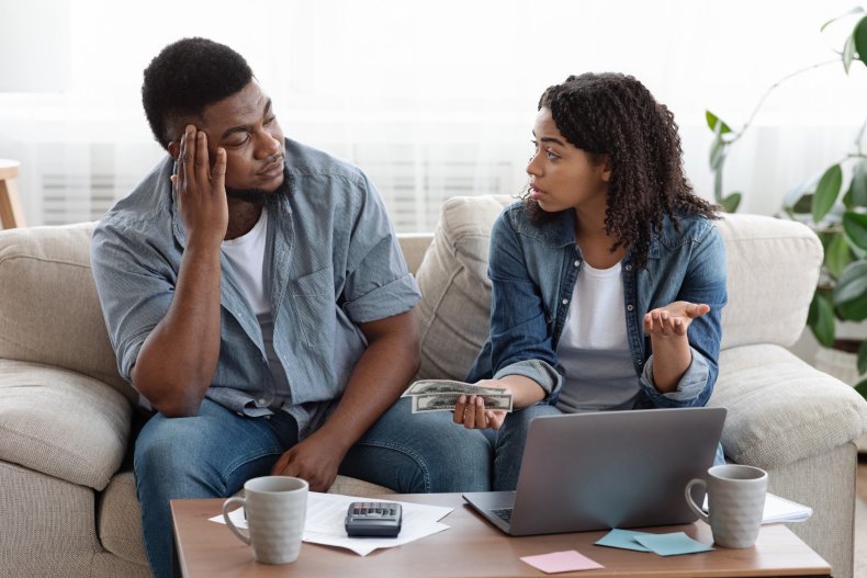 Couple looking at laptop discussing finances. 