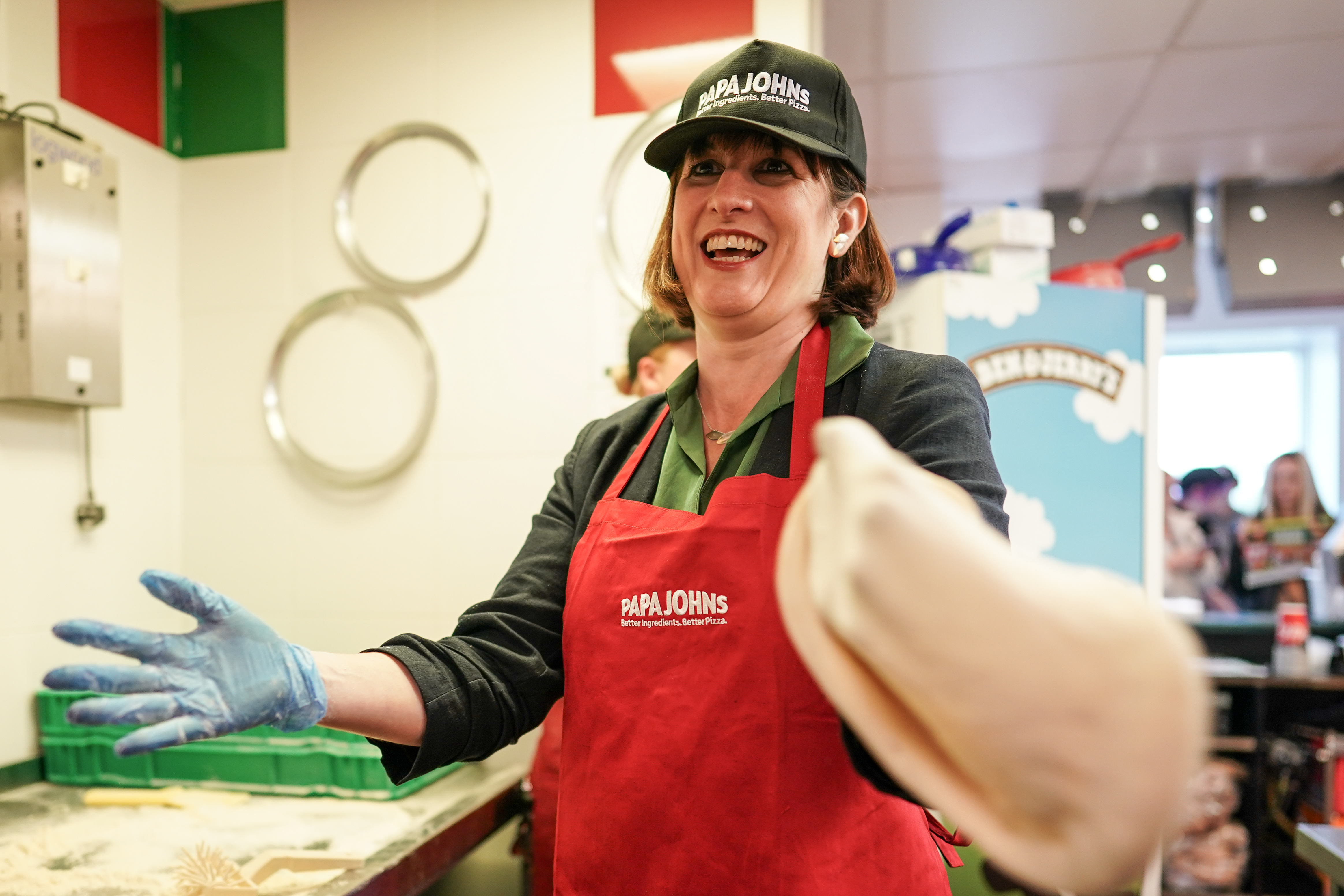 Rachel Reeves, Labour's Shadow Chancellor of the Exchequer, makes pizza in the Papa Johns restaurant during a visit to Primrose Valley Holiday Park