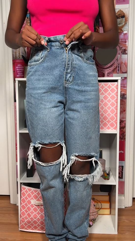 She brought the jean button over a belt loop