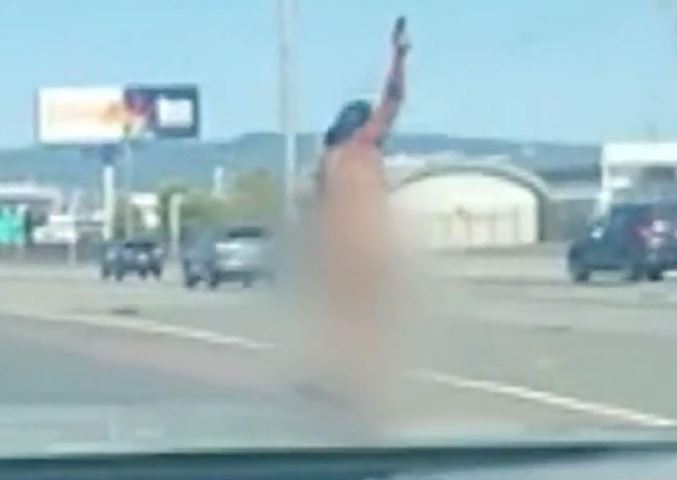The woman was filmed shooting in the air on the bridge