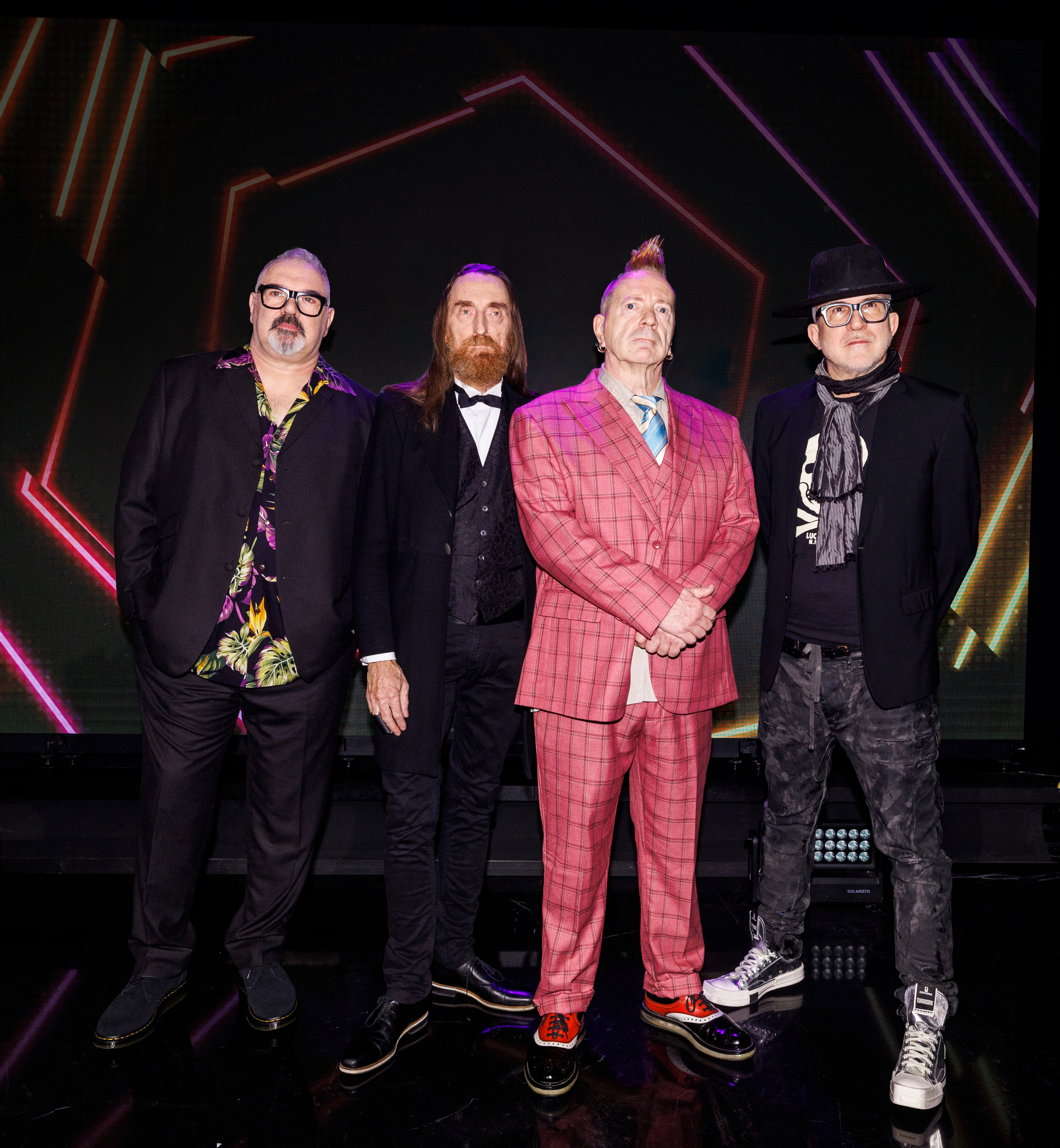 Lydon, in pink suit chosen by his late wife Nora, with his PIL bandmates