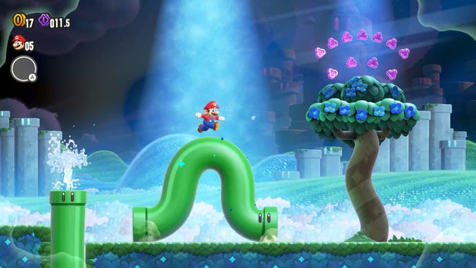Ein Screenshot von Super Mario Bros. Wonder, der Mario auf einer sich windenden grünen Pfeife zeigt.