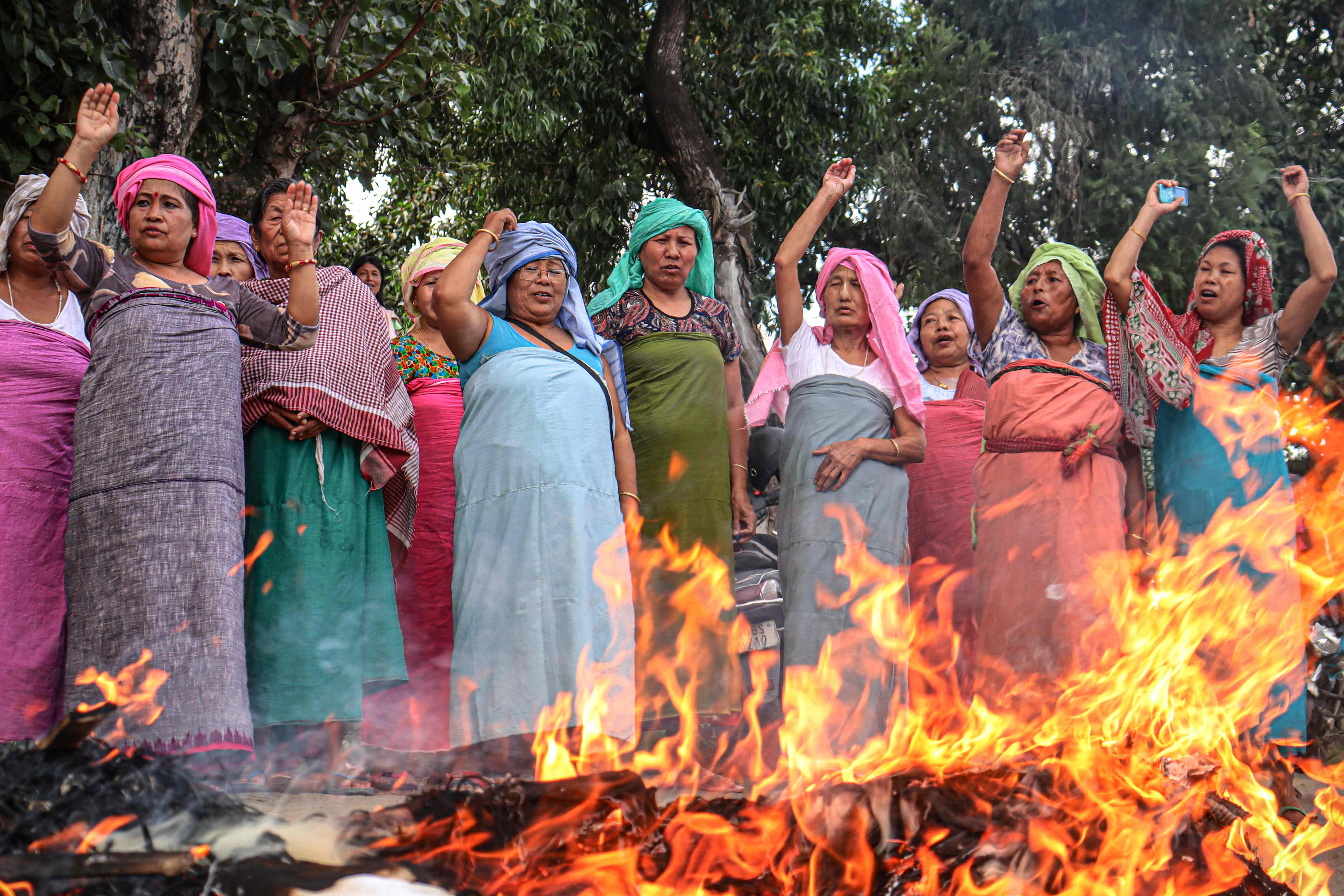 Demonstranten schreien, während sie Bildnisse indischer und manipuritischer Politiker verbrennen