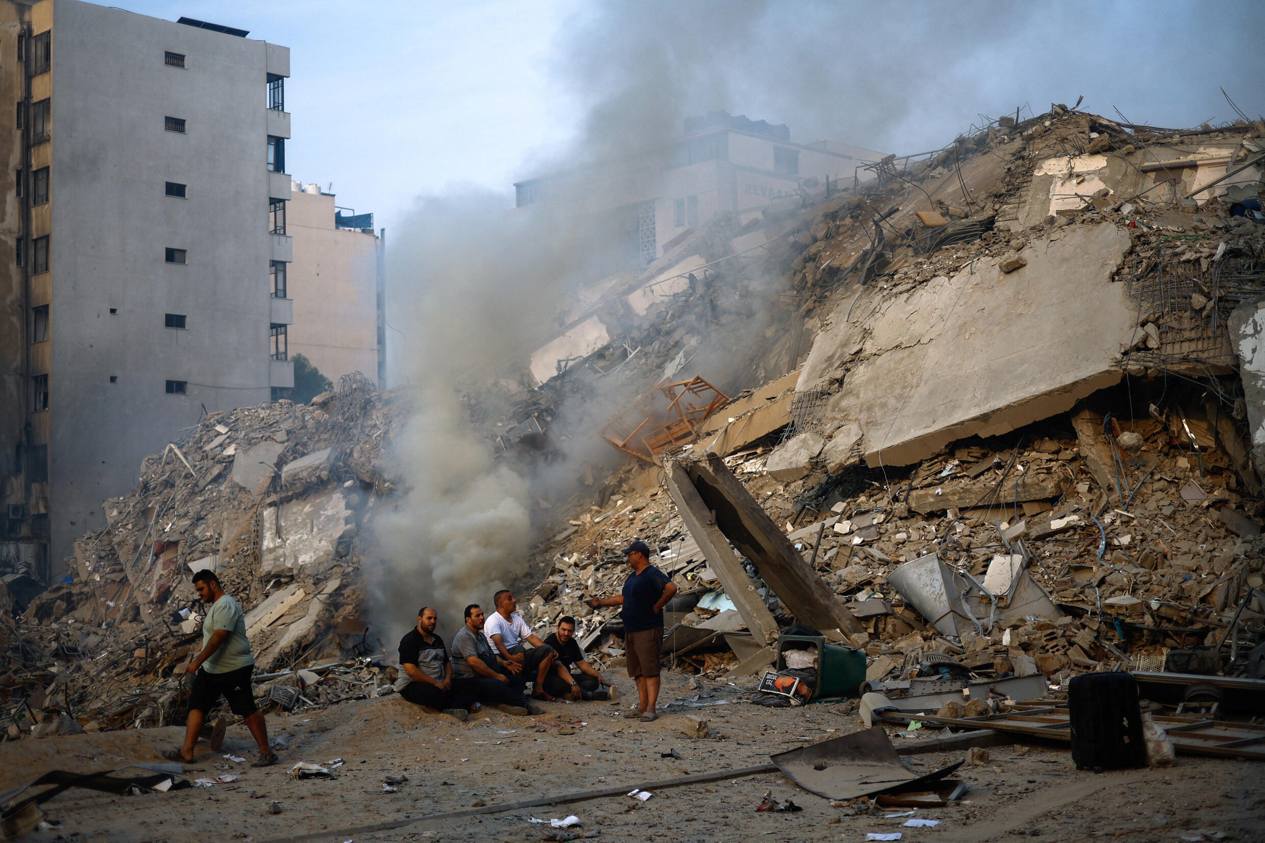 Palästinenser versammeln sich am 8. Oktober 2023 in Gaza-Stadt neben den Ruinen des Watan-Turms, der bei israelischen Angriffen zerstört wurde.