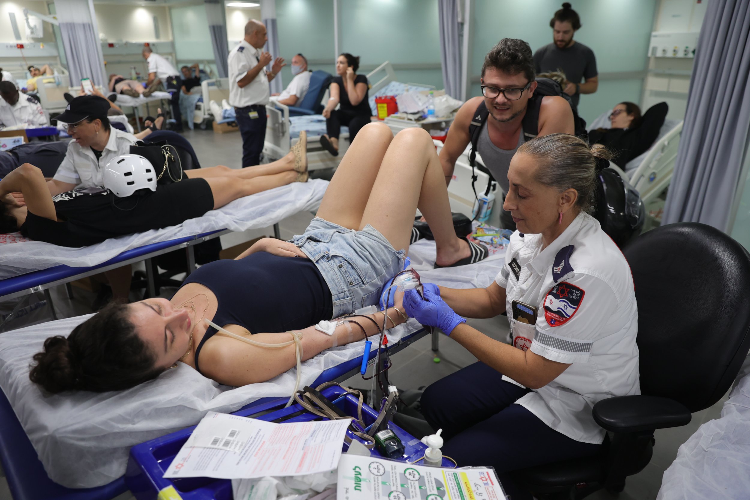 Numerous volunteers waited at Israeli hospitals for their turn to donate blood for victims