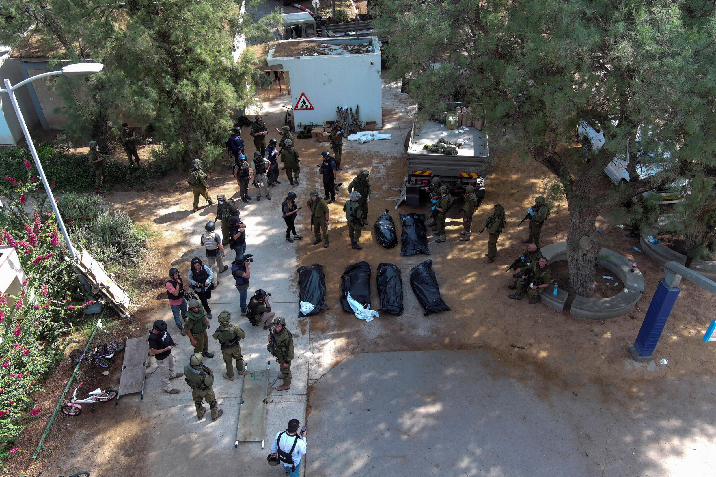 Eine Luftaufnahme zeigt die Leichen von Opfern, die nach dem Massaker im Kibbuz Kfar Aza im Süden Israels am 10. Oktober 2023 aufgebahrt wurden.