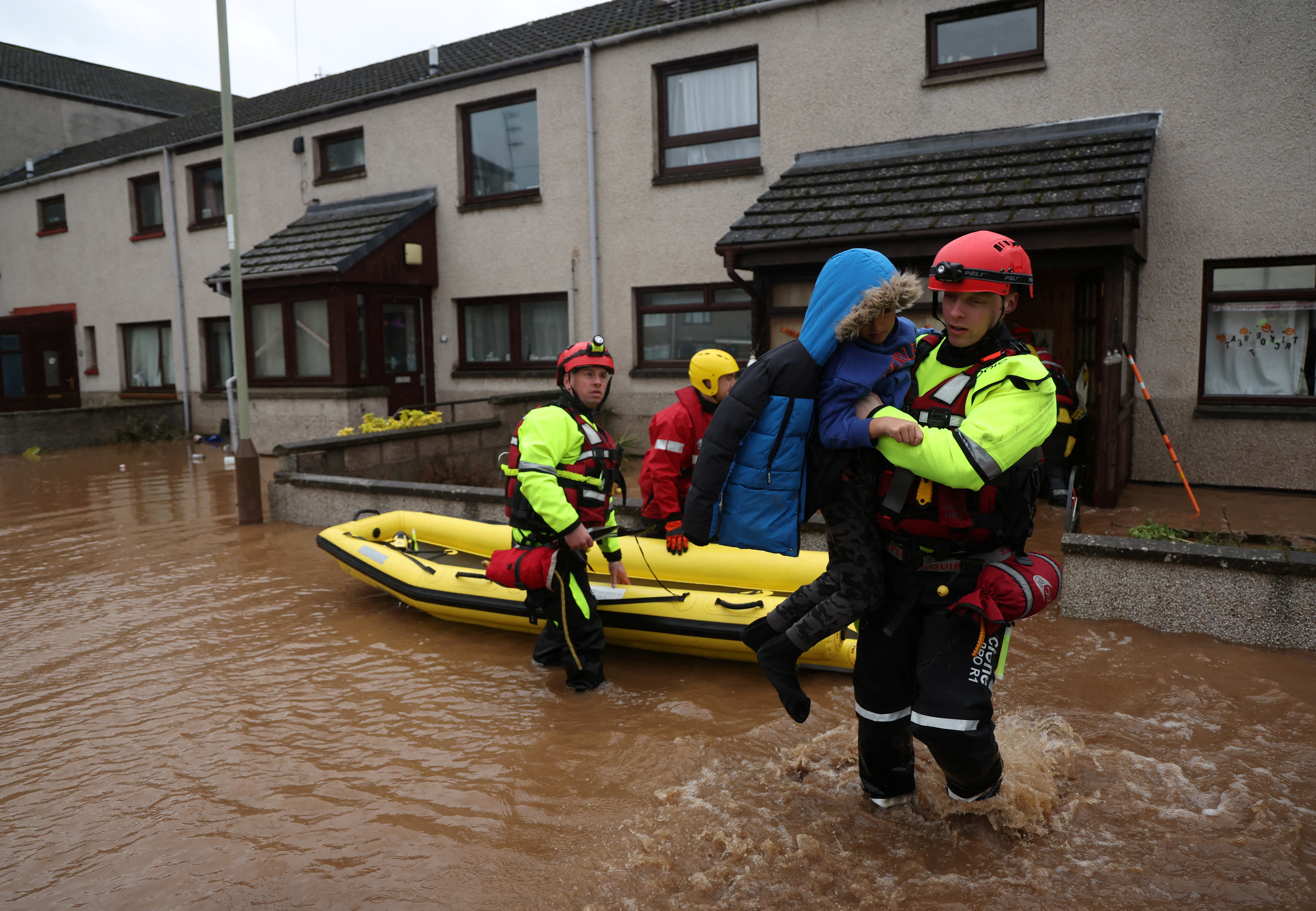 Emergency services assist in the evacuation of a family from their home in Brechin