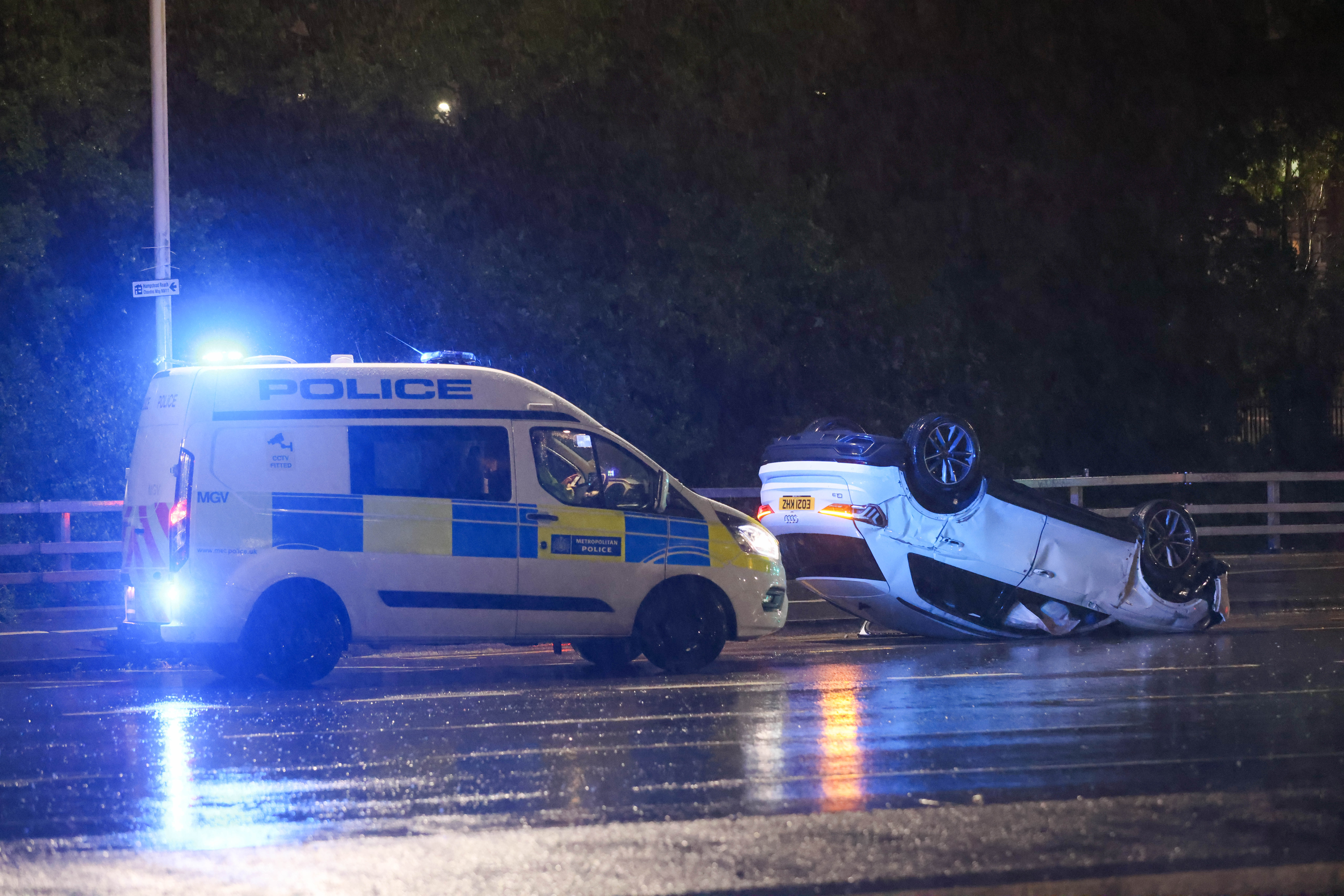 Severe flooding in London has caused dangerous driving conditions with one motor flipping over