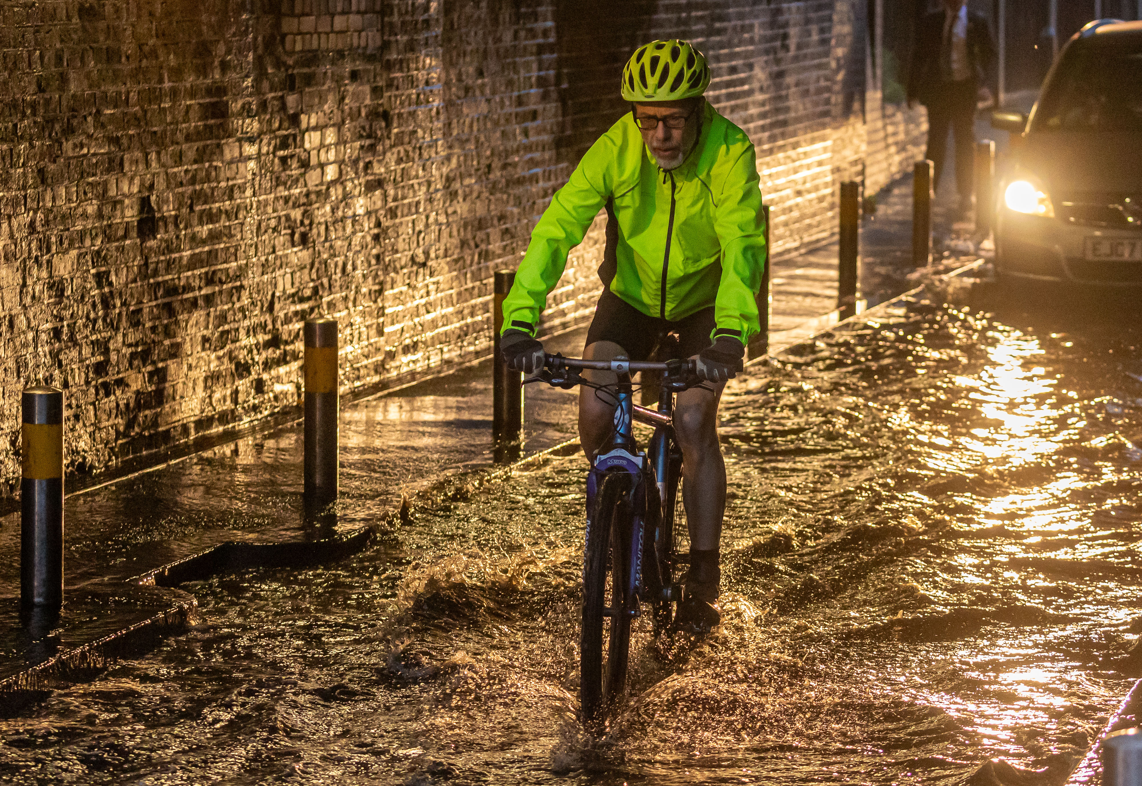 A cyclist caught in flooding this morning in Wimbledon, south-west London