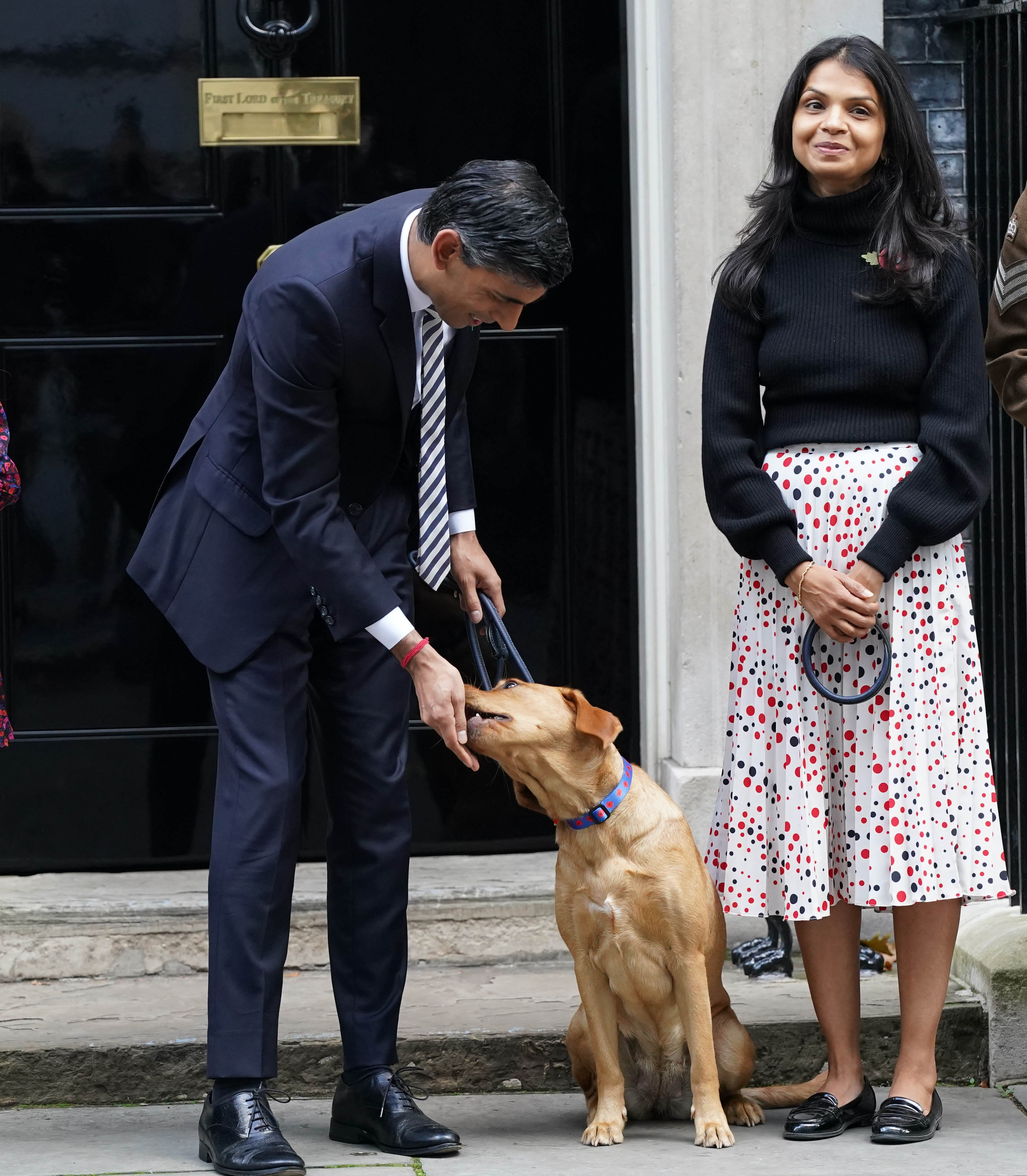 Rishi outside No 10 Downing Street with his wife Akshata and their family dog Nova