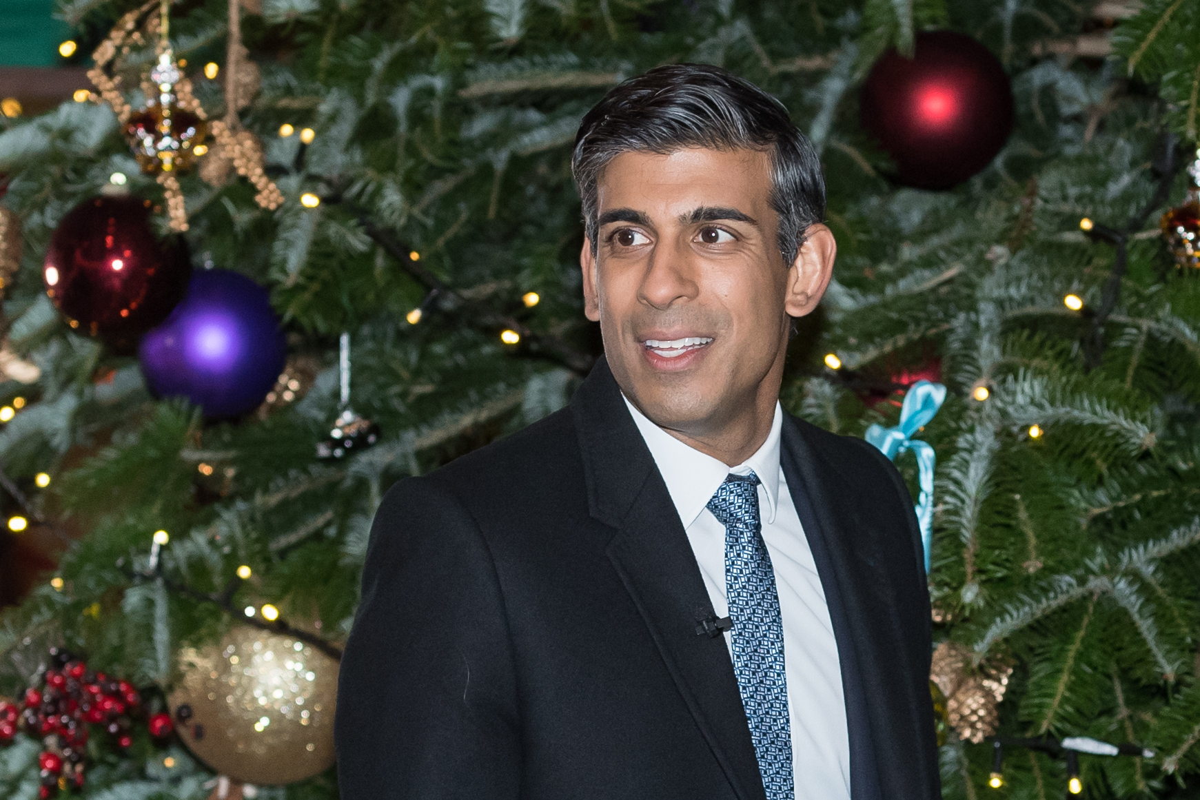 December, 2022: Rishi stands in front of a Christmas Tree while hosting a festive market for small businesses in Downing Street