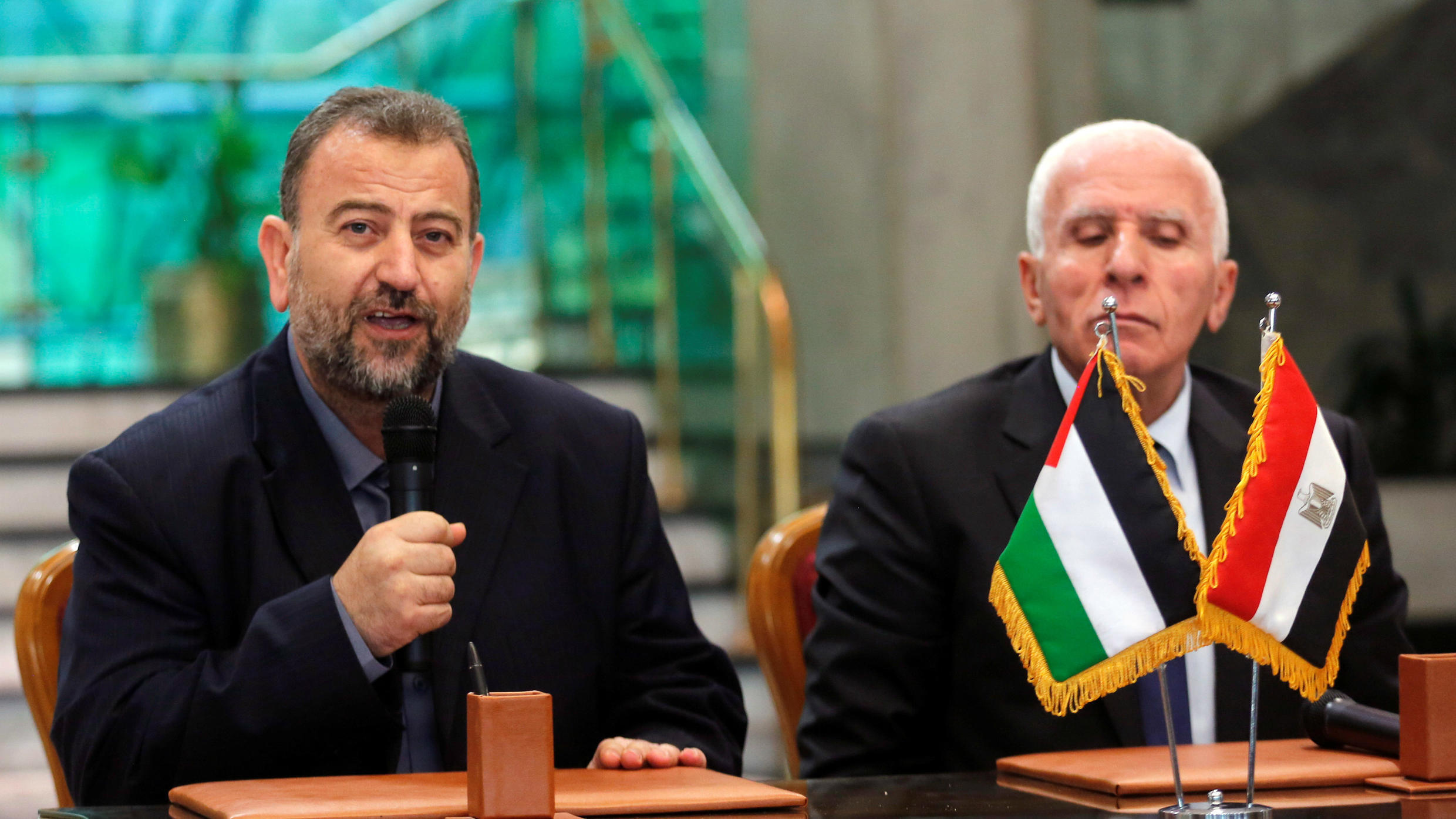 Saleh al-Arouri attends a press conference with Fatah leader Azzam Ahman in Cairo on October 2017.
