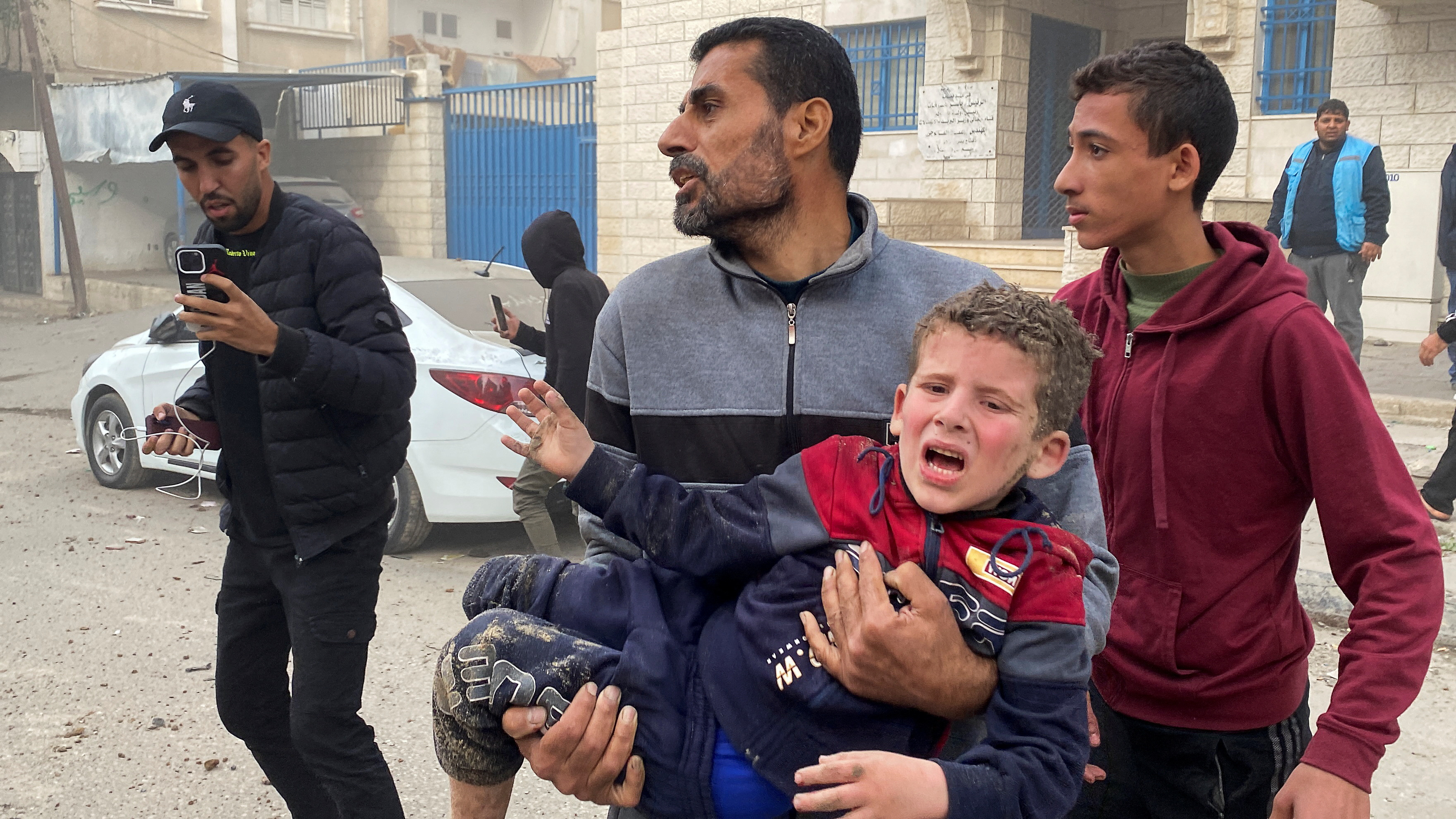 Ein Palästinenser trägt nach einem israelischen Angriff ein Kind im Arm