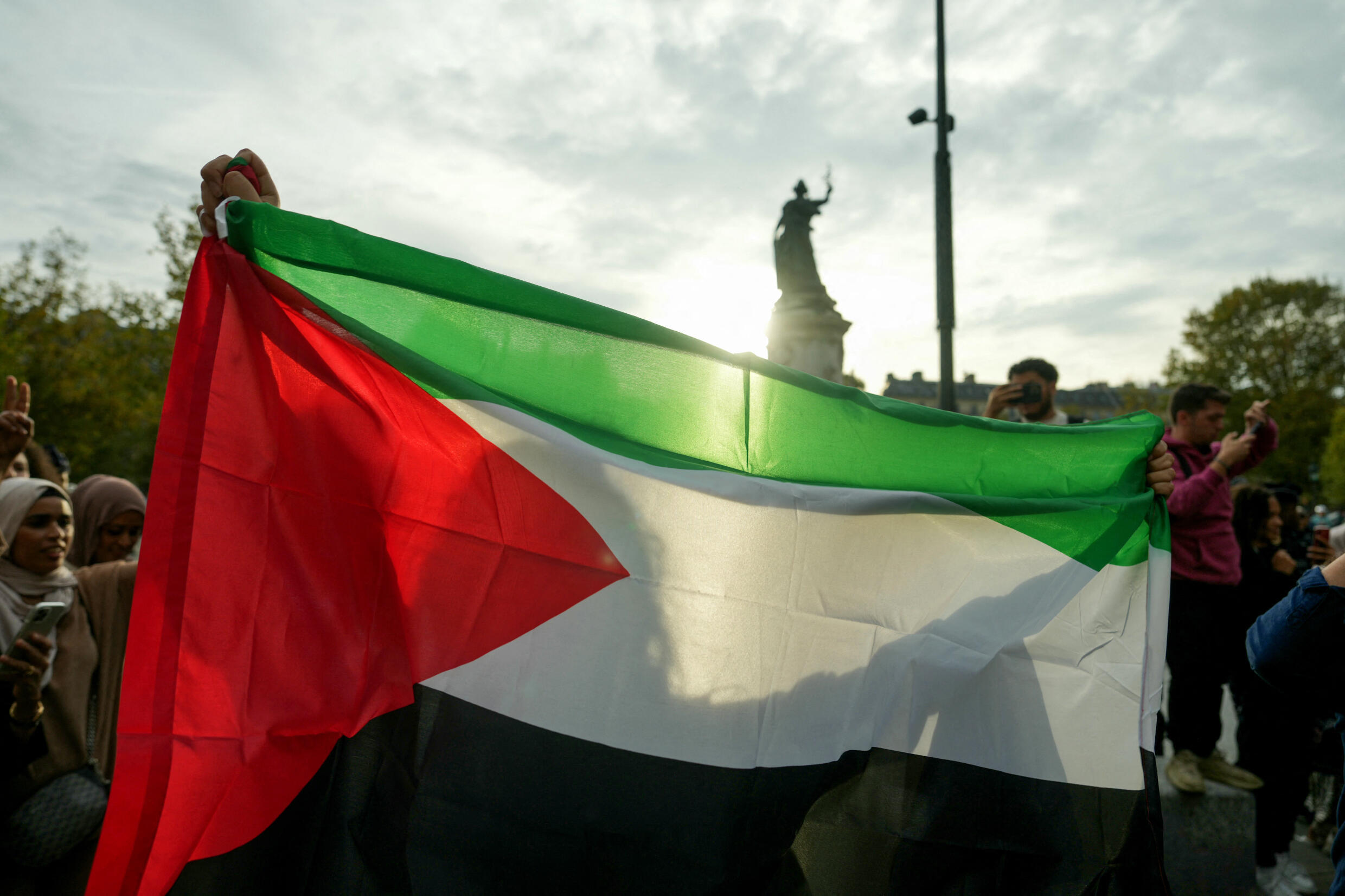 A protester holds up a Palestinian flag at an unauthorised rally in solidarity with Gaza held in central Paris on October 12, 2023. 