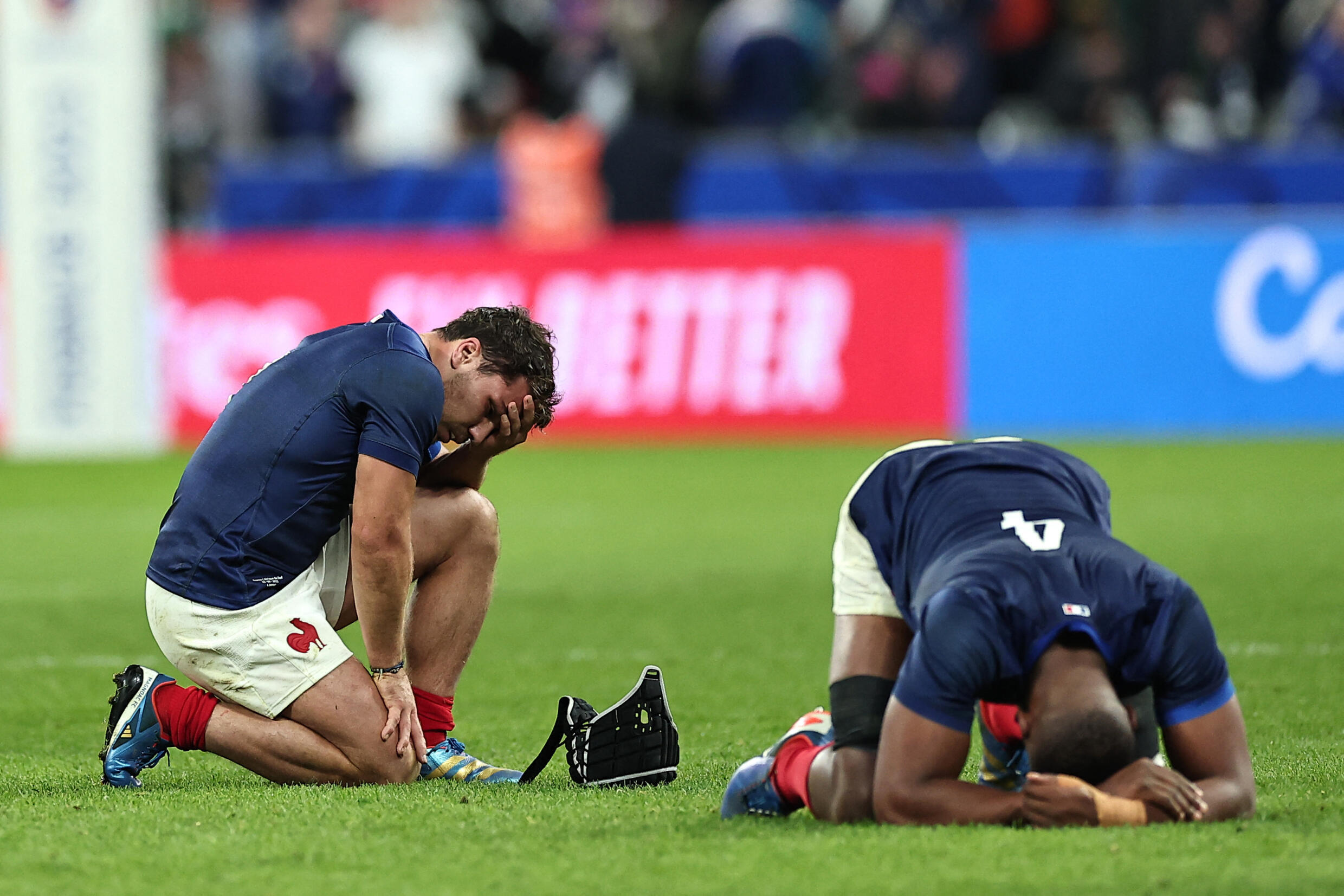 France's captain Antoine Dupont (left) and lock Cameron Woki react after the hosts' quarter-final defeat at the Rugby World Cup. 