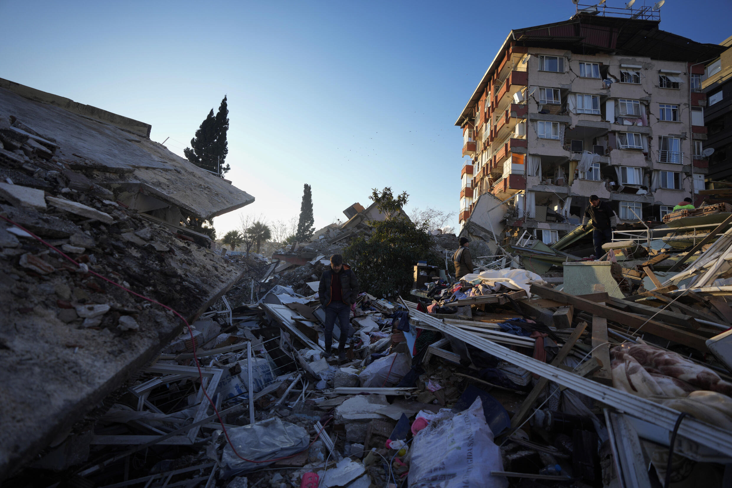 A man walks through the rubble of destroyed buildings in Antakya, southern Turkey, on February 8, 2023.