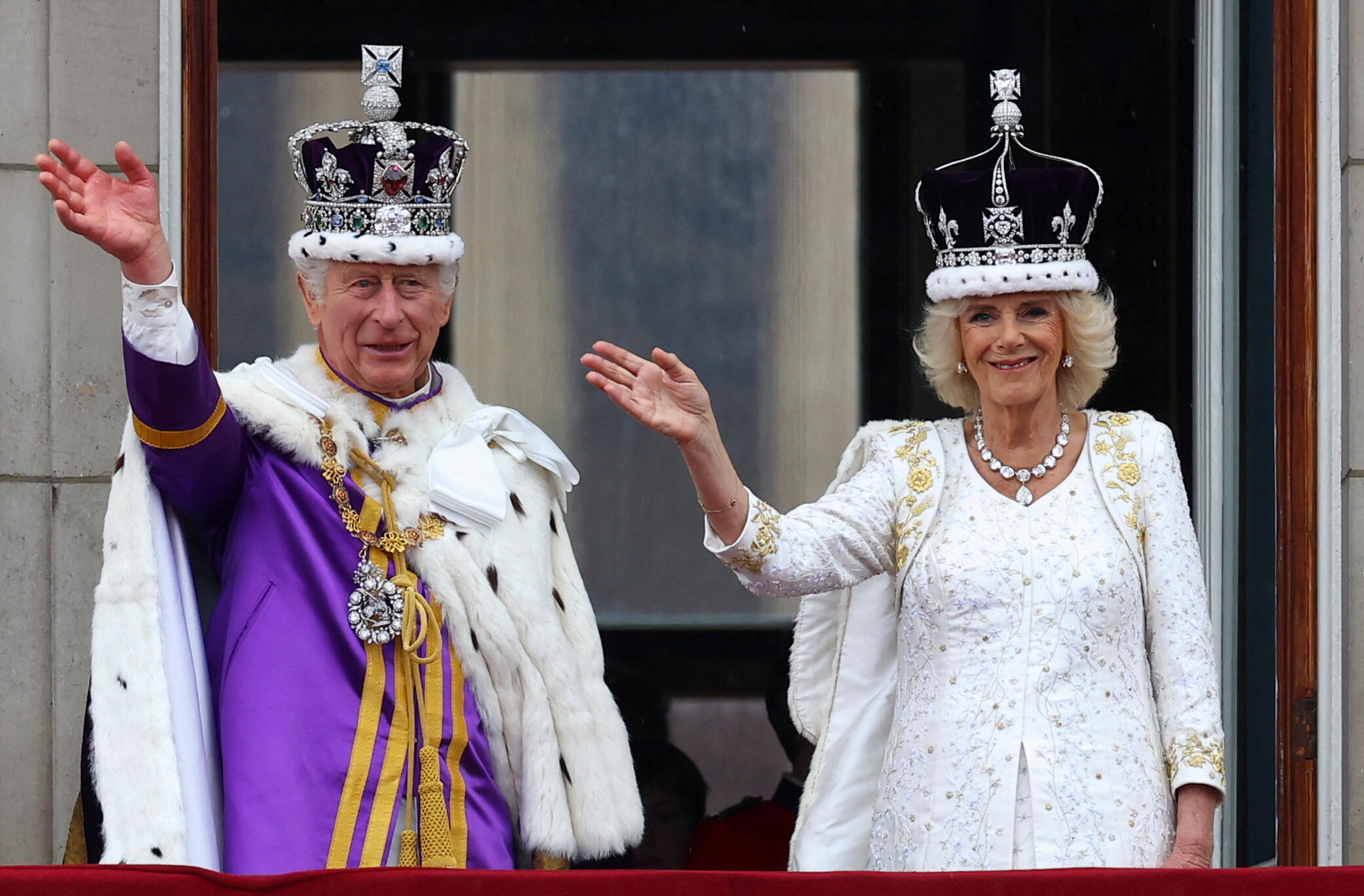 Newly crowned King Charles III and Queen Camilla wave from the balcony of Buckingham Palace after their coronation ceremony in London on May 6, 2023.