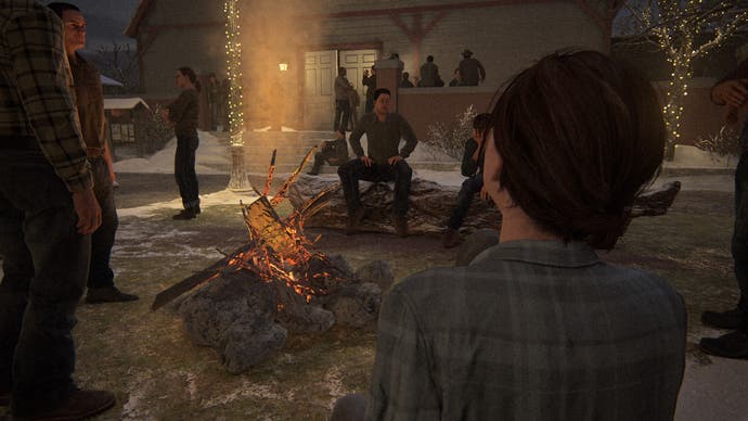 Die verlorenen Level: Jackson Party.  Ellie sitzt auf einem Baumstamm vor einem Feuer.  Menschen drängen sich um das Feuer, während Lichterketten in der Dunkelheit um sie herum leuchten.