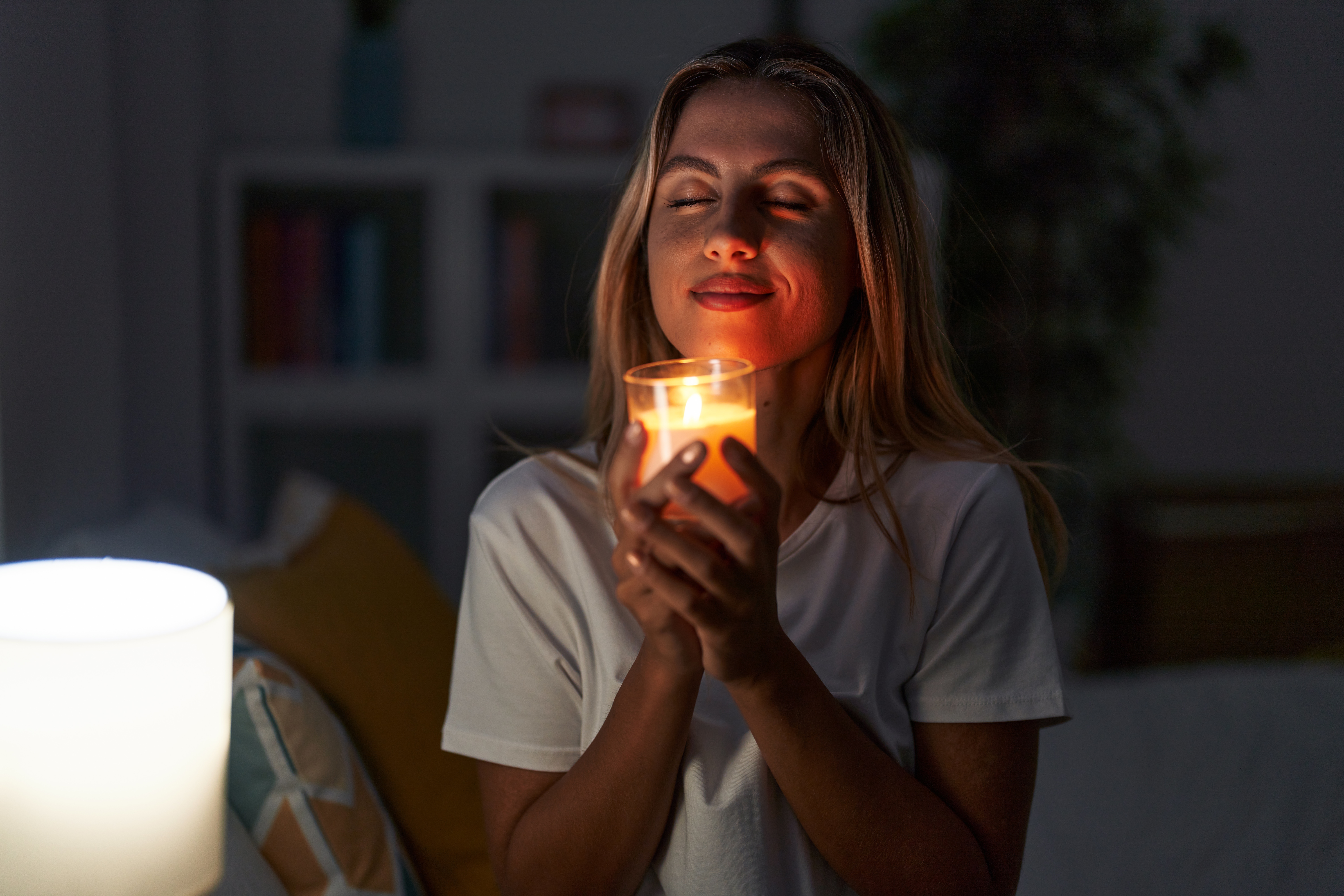 Avoid overhead lights and use a lamp or, even better, a candle