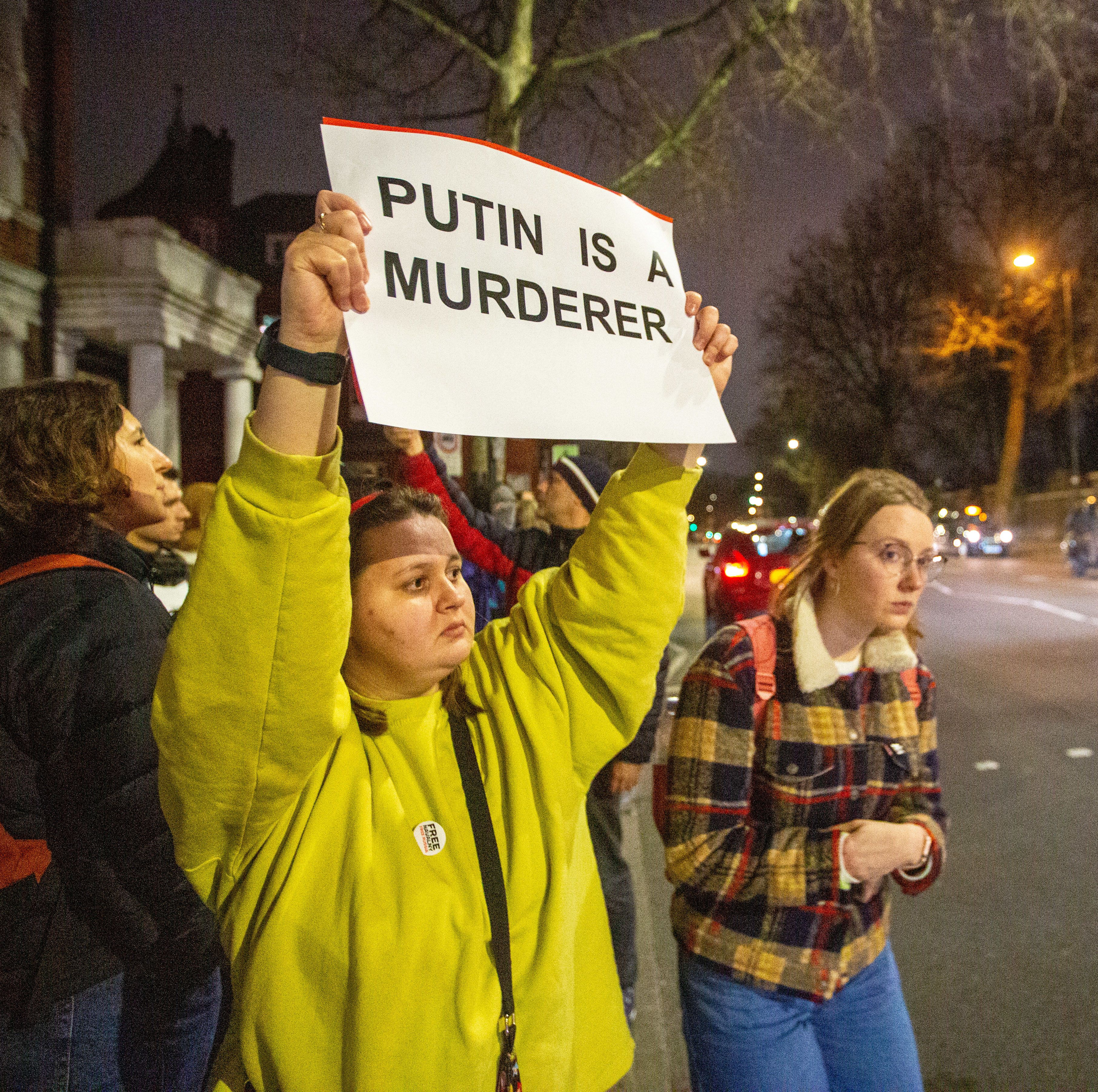 Protesters held placards in London that called Vladimir Putin a war criminal