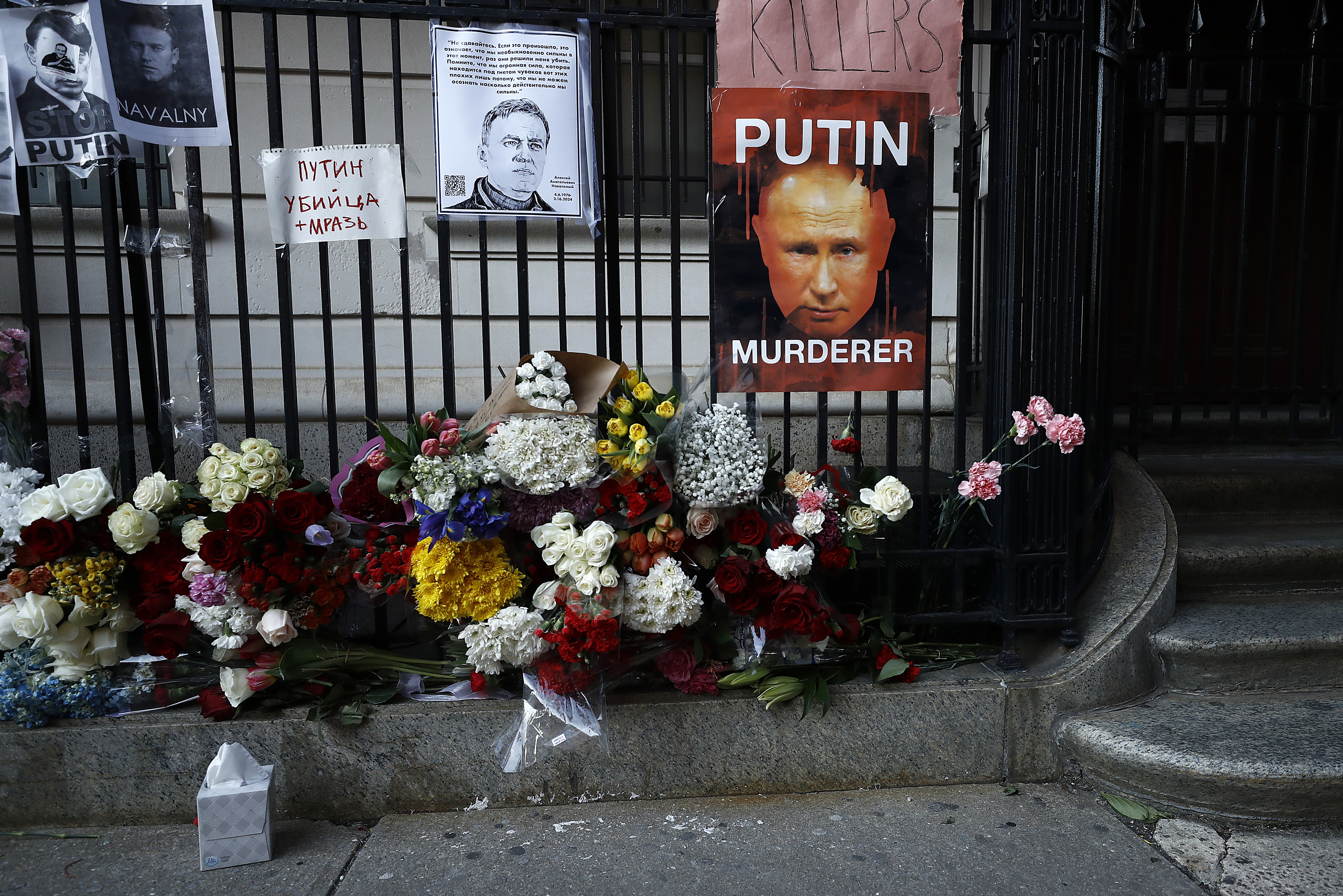 Flowers and signs are placed outside the Russian Consulate for Navalny
