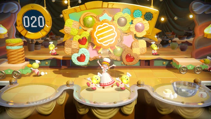 Princess Peach: Showtime-Screenshot, der ein Back-Minispiel mit Kuchen auf einem Förderband zeigt.