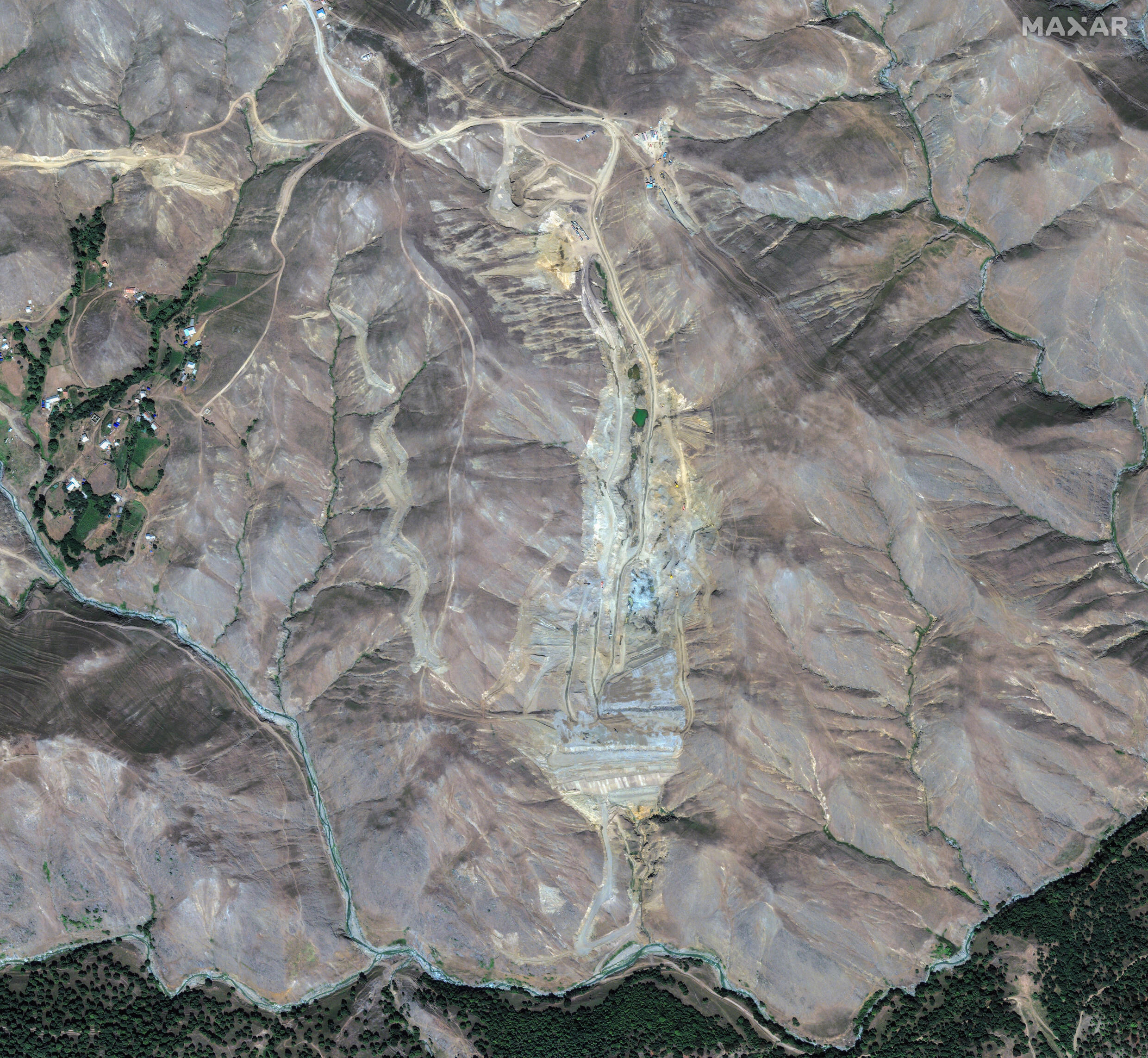 This satellite image from 2012 show the location where a waste-containment reservoir known as a tailings pond will later be built at the Gedabek mine in Azerbaijan.