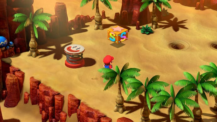 Auf diesem Bildschirm aus Super Mario RPG ist Mario in der Wüste.  Vor ihm liegt eine Umrandung aus Palmen, ein Rettungsblock, ein Sprungbrett und ein paar Sandstrudel.
