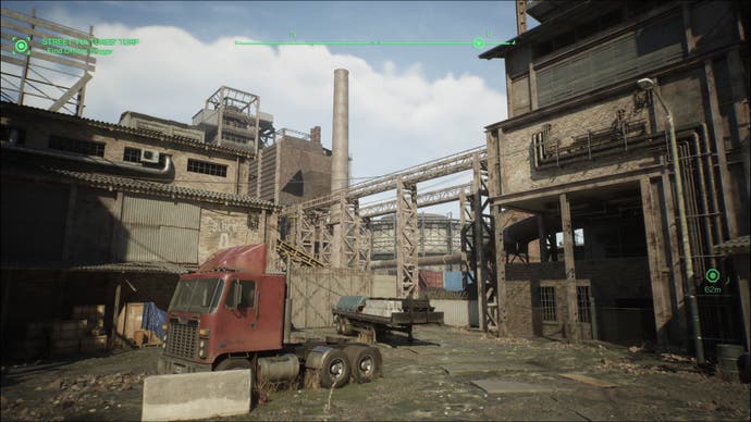 Ein Screenshot von RoboCop: Rogue City, der ein heruntergekommenes Stahlwerk zeigt.  Im Vordergrund steht das Fahrerhaus eines Lastwagens, umgeben von Backsteinkonstruktionen und einem Industrieschornstein.